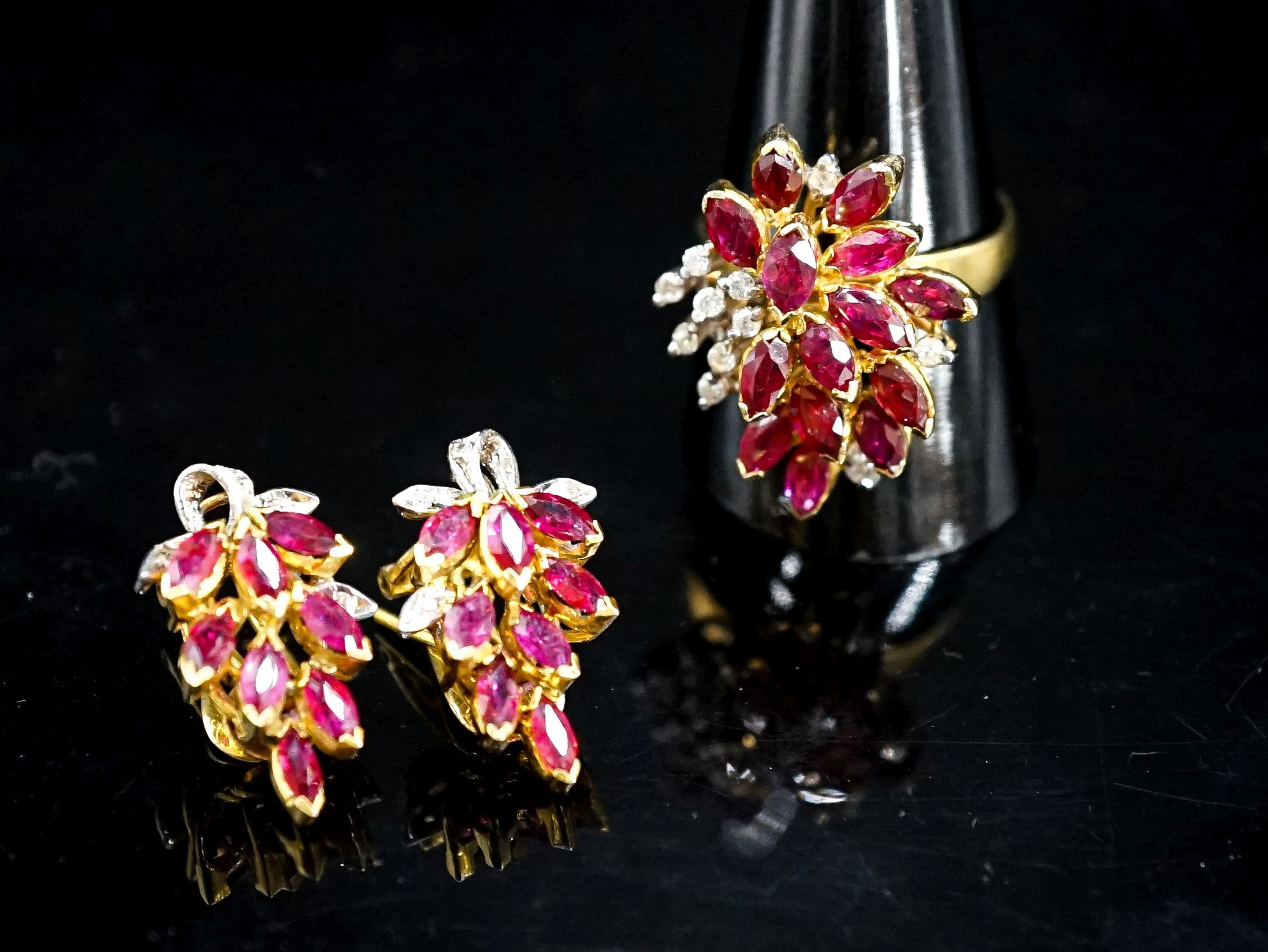 A modern 585 yellow metal, ruby and diamond cluster dress ring, size T and a pair of matching earrings, gross 14.1 grams.